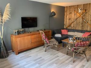 a living room with a couch and a table at Magic Mountain Winterberg Ferienwohnung near Bikepark with Pool Sauna in Winterberg