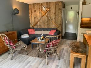 a living room with a couch and a table and chairs at Magic Mountain Winterberg Ferienwohnung near Bikepark with Pool Sauna in Winterberg