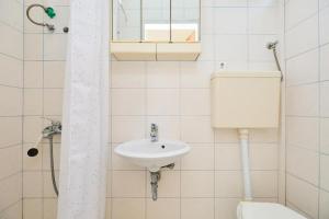 a bathroom with a toilet and a sink at Seaside secluded apartments Cove Sutmiholjska, Mljet - 22318 in Blato