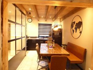 a dining room with a table and a kitchen at Chalet Pearl Winterberg Modern Wifi 6 Personen near by Bikepark in Winterberg