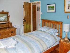 AustwickにあるSpoutscroft Cottageのベッドルーム1室(ベッド1台、ドレッサー、鏡付)