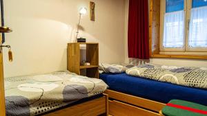 a room with two beds and a window at FEWO Marion in Oberstaufen