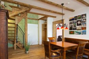 a dining room with a wooden table and chairs at Alpenblick in Oberstaufen