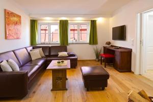 a living room with a couch and a table at Alpenblick in Oberstaufen