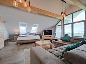a living room with a bed and a couch at Cornelius-05 in Norderney