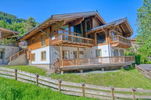 a large log home with a large deck at Chalet Schmitten - by Alpen Apartments in Zell am See