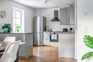 a kitchen with stainless steel appliances and a table at Villa Alpenbach - by Alpen Apartments in Zell am See