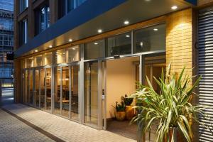 a building with glass doors and plants in front at Residence Inn by Marriott London Tower Bridge in London