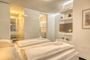 Postel nebo postele na pokoji v ubytování Design-Suite Pasithéa - by Alpen Apartments