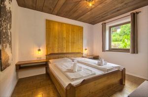 a bedroom with a large bed with a window at Haus Kitzsteinhorn 6 - by Alpen Apartments in Kaprun