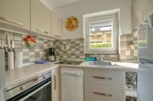 a kitchen with a sink and a window at Apartment Valentina - by Alpen Apartments in Zell am See