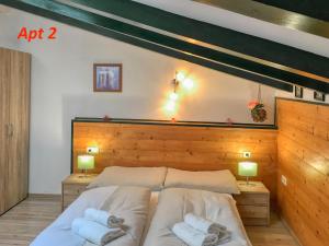 a bedroom with a bed with two pillows at Apartment Valentina - by Alpen Apartments in Zell am See