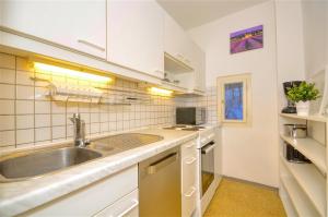 a kitchen with a sink and a counter top at Mozart Top 3 - by Alpen Apartments in Zell am See