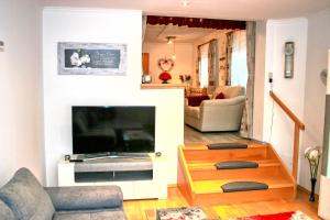 a living room with a large television and a living room at Apartment Birke 3 - by Alpen Apartments in Bad Gastein