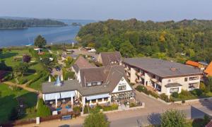 an aerial view of a large house with a lake at Haus Schwanensee PLÖNI 12 in Bosau