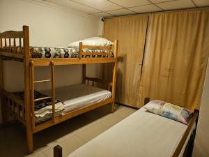 a room with two bunk beds and a bed at Apartaments Malecon 2000 in Guayaquil