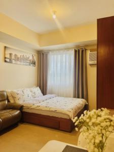 a small bedroom with a bed and a window at City View Studio Unit at Aspira Tower 1 in Cagayan de Oro