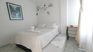Un pat sau paturi într-o cameră la Hotel Miami en Melgar