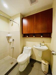a bathroom with a toilet and a sink at City View Studio Unit at Aspira Tower 1 in Cagayan de Oro