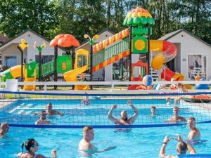 a group of people in a pool at a water park at Holiday cottages, pool, whirlpool, D bki in Dąbki