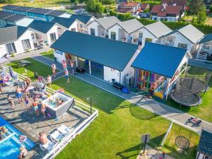 una vista aérea de un parque infantil con piscina y gente en Holiday cottages, pool, whirlpool, D bki, en Dąbki
