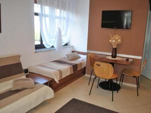 a hotel room with two beds and a desk and a television at Villa in Brenna near Ski Lifts & Pool in Brenna