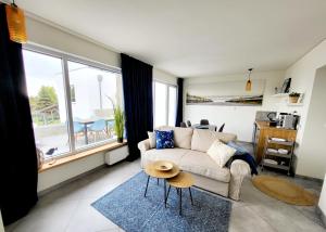 a living room with a couch and a table at Willa Plażowa in Rewa