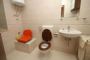 a small bathroom with a toilet and a sink at Apartments with a parking space Mocici, Dubrovnik - 9081 in Mlini +22 photos