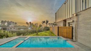 a swimming pool in the backyard of a house at Jeju Family Garden Village in Jeju