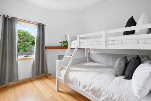 a white bunk bed in a room with a window at LuCo House Stanley in Stanley