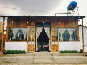 une maison avec des portes et des fenêtres en bois dans l'établissement Homestay KV Houses - Cầu Đất, à Xuân Trường