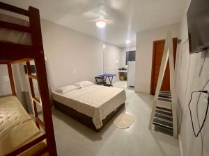 a bedroom with a bed and a staircase in it at Âncora Lofts in Arraial do Cabo