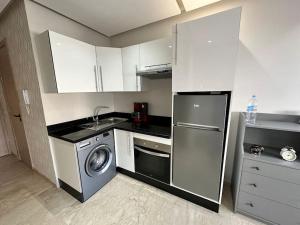 a kitchen with a washing machine and a washer at Racine Studio bd Anfa in Casablanca