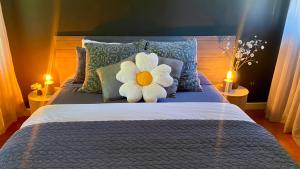 a bed with a white flower on top of it at Phillip Island Nature Resort Villas in Cowes