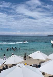 a group of people in the water at the beach at Tours Mandala Beach in Baru