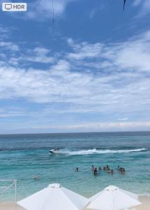 a group of people in the water at the beach at Tours Mandala Beach in Barú