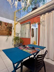 a blue table and chairs in a patio at GayFriendly Hostel BSB Airport in Brasilia