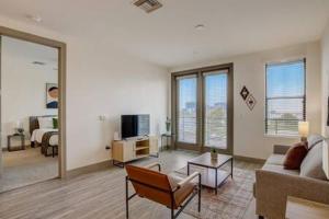 a living room with a couch and a tv at Modern 2BR CozySuites on Town Lake waterfront 13 in Tempe