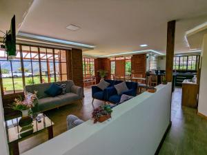 a living room with two couches and a kitchen at Casa de Campo Don Panchito 