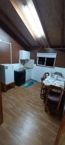 a large room with a table and a kitchen at Cabañas Lepihue in Maullín +31 photos