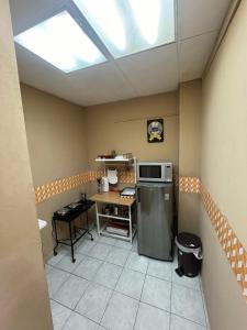 a kitchen with a refrigerator and a table and a skylight at Apto. mejor zona de San Salvador in San Salvador