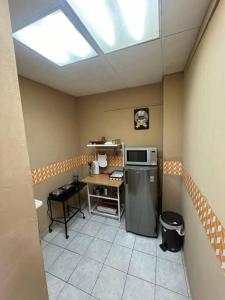 a small kitchen with a refrigerator and a table at Apto. mejor zona de San Salvador in San Salvador