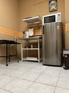 a kitchen with a refrigerator and a microwave at Apto. mejor zona de San Salvador in San Salvador