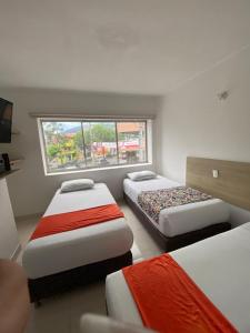 Postel nebo postele na pokoji v ubytování Suites Laureles