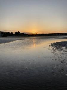 a body of water with the sunset in the background at Shore beats working in Port Sorell