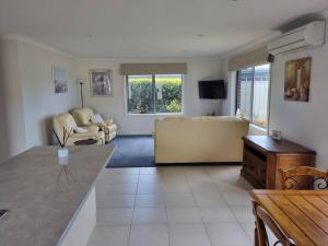 a living room with a couch and a tv at Shore beats working in Port Sorell