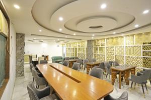 a dining room with tables and chairs and a ceiling at Hotel Ambrosia - A Boutique Hotel in New Delhi