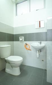 a bathroom with a toilet and a sink at Seaview Akelinee Apartment 3 in Kuala Terengganu