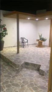 a room with a table and a chair and a tiled floor at Habitacion en casa familiar in Barranquilla
