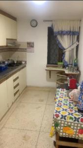 a kitchen with a sink and a table in a room at Habitacion en casa familiar in Barranquilla